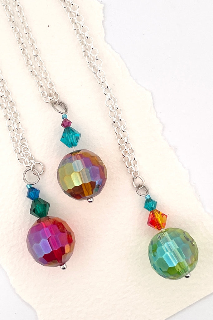 Eye catching colourful crystal beads hung from a silvery bail. 
