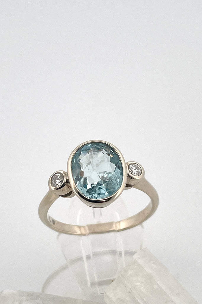 A signature designer piece. This classically styled ring holds a magnificent 10x8mm 2ct+ completely natural and unheated Mozambique Aquamarine with a sparkling 0.03ct F-G VS diamond on either side.