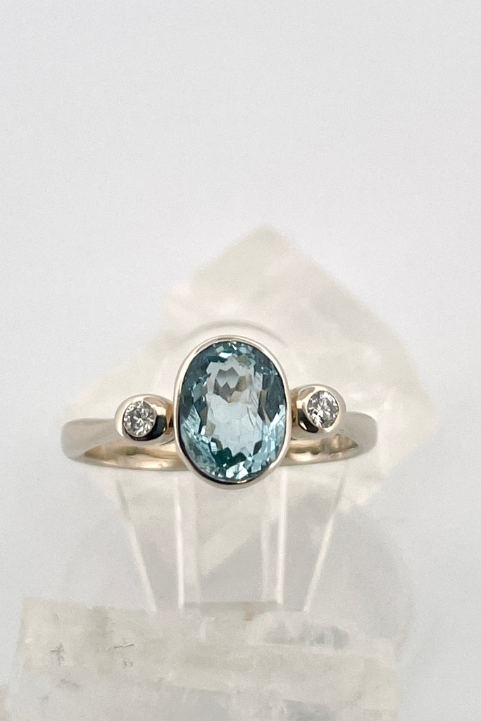  This classically styled ring holds a magnificent 8x6mm 1ct+ completely natural and unheated Mozambique Aquamarine with a sparkling 0.03ct F-G VS diamond on either side.