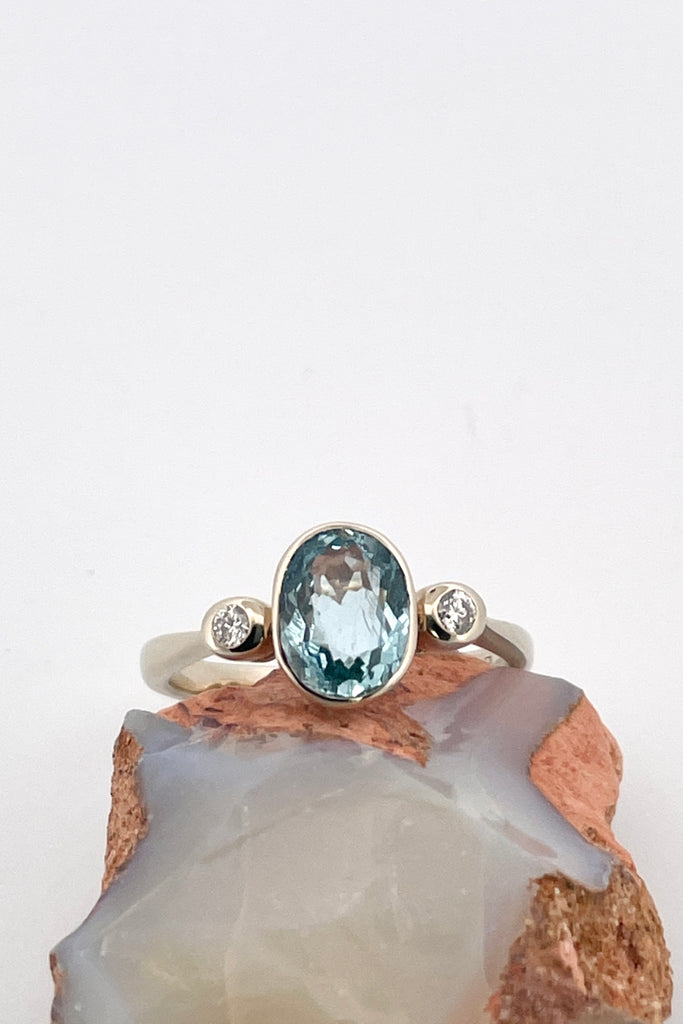  This classically styled ring holds a magnificent 8x6mm 1ct+ completely natural and unheated Mozambique Aquamarine with a sparkling 0.03ct F-G VS diamond on either side.