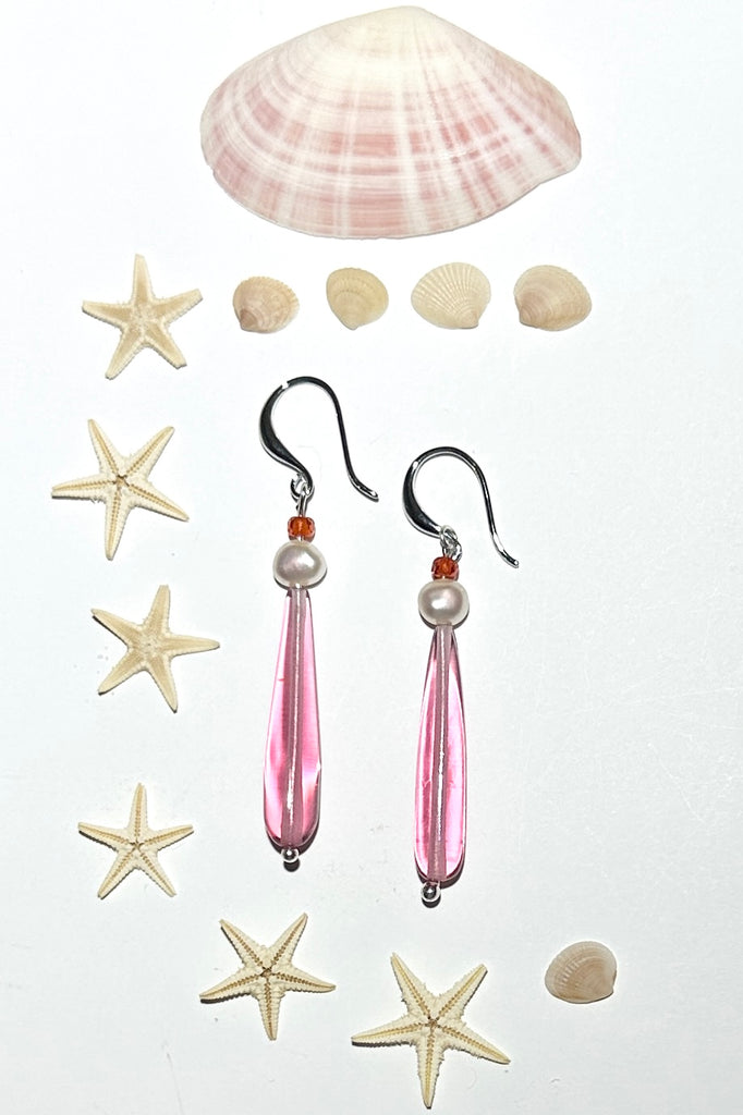 Drop earrings as pretty as a rosebud, a perfect soft pink crystal with a pearl. Soft as a summer morning.

Pale pink crystal with a white pearl.