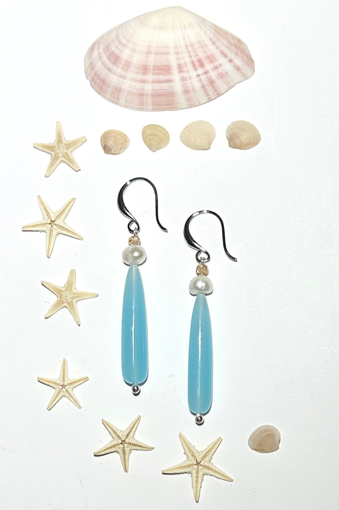 Drop earrings as pretty as a morning lagoon, a perfect soft blue Quartz, as soft as a summer splash.

Soft sea blue Quartz with a white pearl and champagne coloured CZ bead