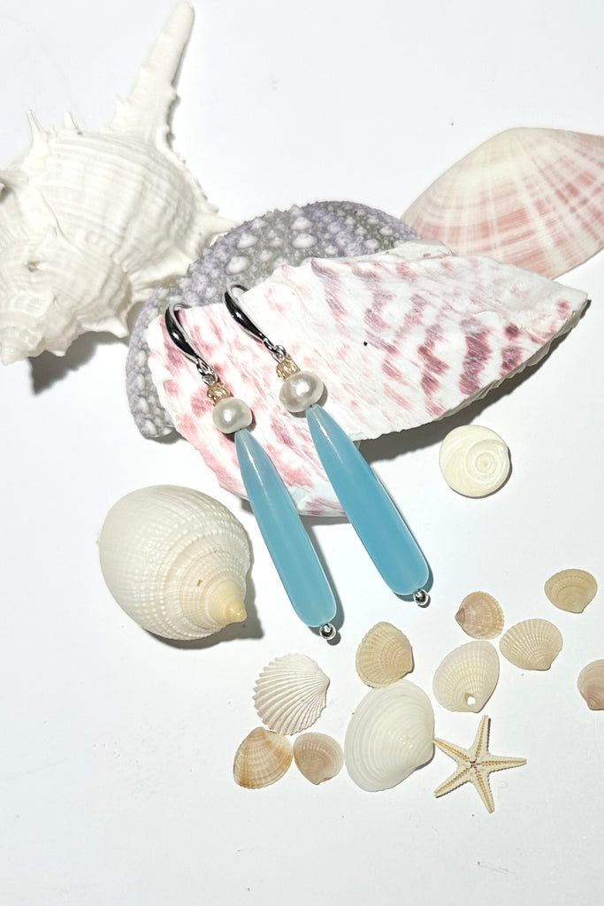 Drop earrings as pretty as a morning lagoon, a perfect soft blue Quartz, as soft as a summer splash.

Soft sea blue Quartz with a white pearl and champagne coloured CZ bead