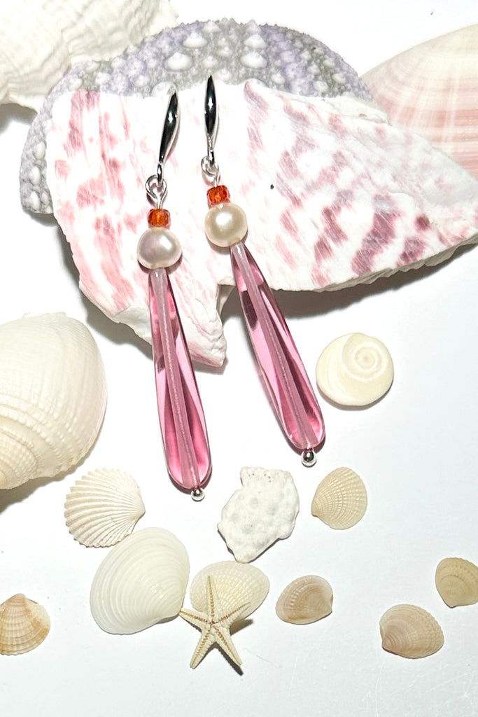 Drop earrings as pretty as a rosebud, a perfect soft pink crystal with a pearl. Soft as a summer morning.

Pale pink crystal with a white pearl.