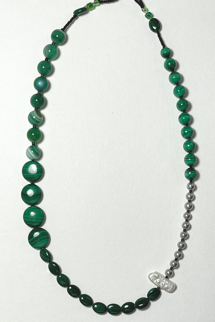The necklace is made with three different shapes of green Malachite stone with a highlight of round grey pearls and one creamy white pearl. Hand made exclusively in Australia for Mombasa Rose Boutique, this is a one off piece, there will never be another.