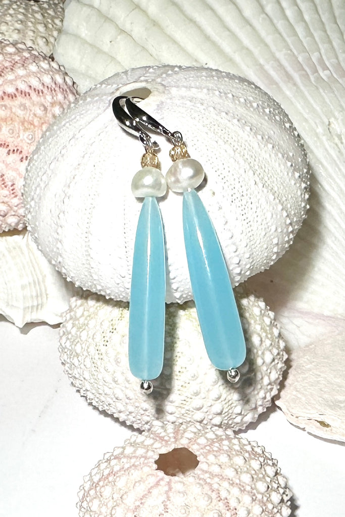 Drop earrings as pretty as a morning lagoon, a perfect soft blue Quartz, as soft as a summer splash.

Soft sea blue Quartz with a white pearl and champagne coloured CZ bead