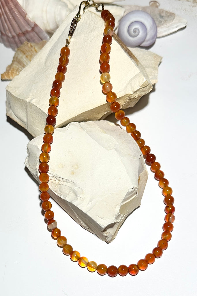 A gemstone bead necklace for everyday, for layering or to wear on its own. Golden amber coloured Carnelian beads.

5mm round polished Carnelian beads.