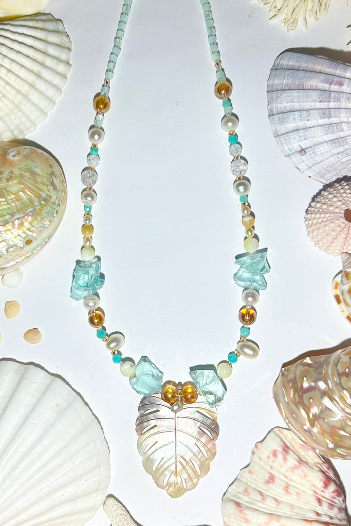 An ocean inspired necklace for island dreaming, as soft and pretty as a turning wave.

Mother of Pearl shell leaf, 8mm white pearls, aquamarine coloured glass shards,
