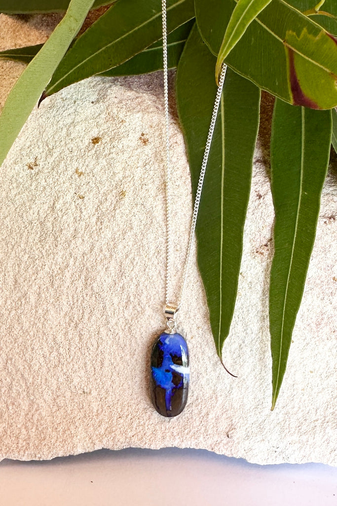 8.94ct Solid Australian boulder Opal, a river of cobalt blue crystal flows down the stone, there is a bright white cloud on one side