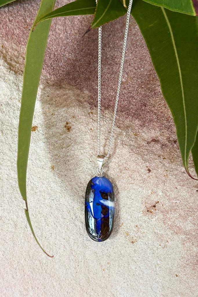 8.94ct Solid Australian boulder Opal, a river of cobalt blue crystal flows down the stone, there is a bright white cloud on one side