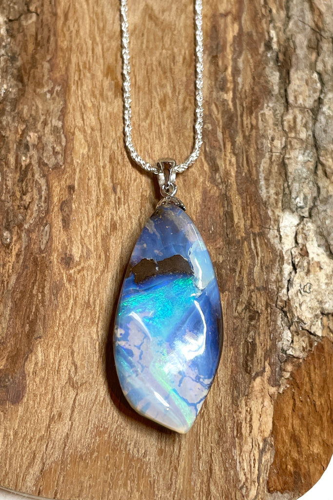 An organic natural piece featuring a small clear jelly opal detail on one side that reveals what is underneath. This piece has so much detail and depth.