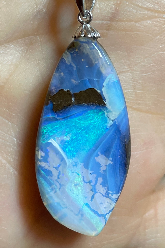 An organic natural piece featuring a small clear jelly opal detail on one side that reveals what is underneath. This piece has so much detail and depth.