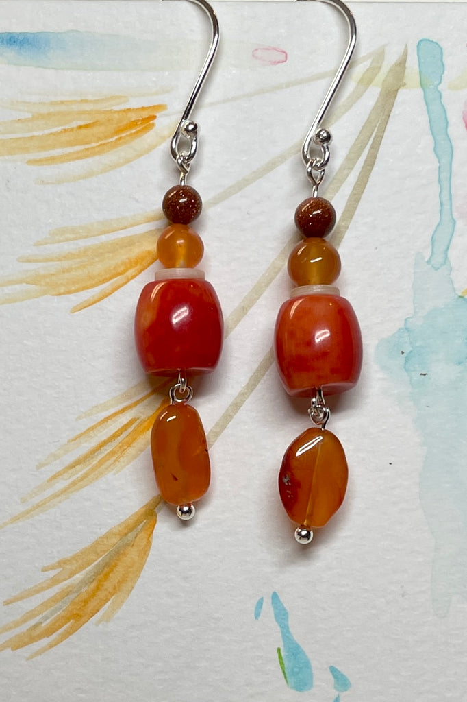 Drop style earrings statement earrings. 925 silver hook earrings. Stones are Carnelian, Sunstone Coloured Branch Coral and seashell.