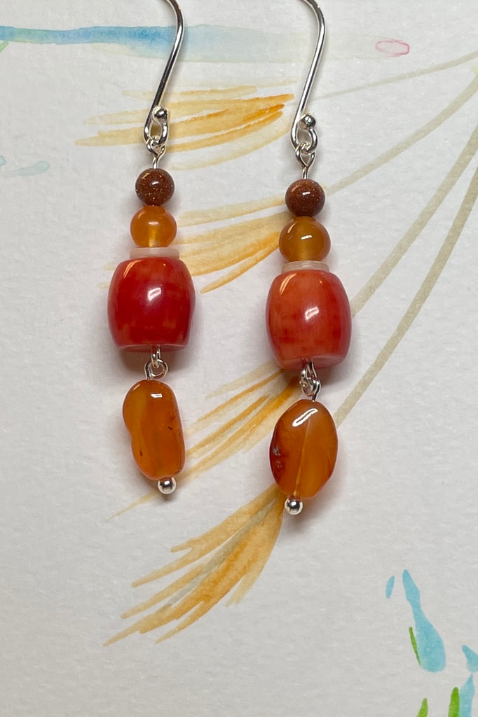 Drop style earrings statement earrings. 925 silver hook earrings. Stones are Carnelian, Sunstone Coloured Branch Coral and seashell.