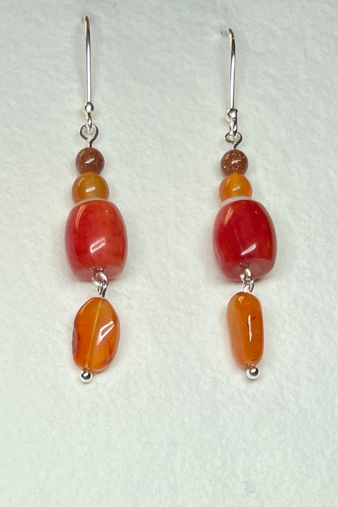 Drop style earrings statement earrings. 925 silver hook earrings. Stones are Carnelian, Sunstone Coloured Branch Coral and seashell.