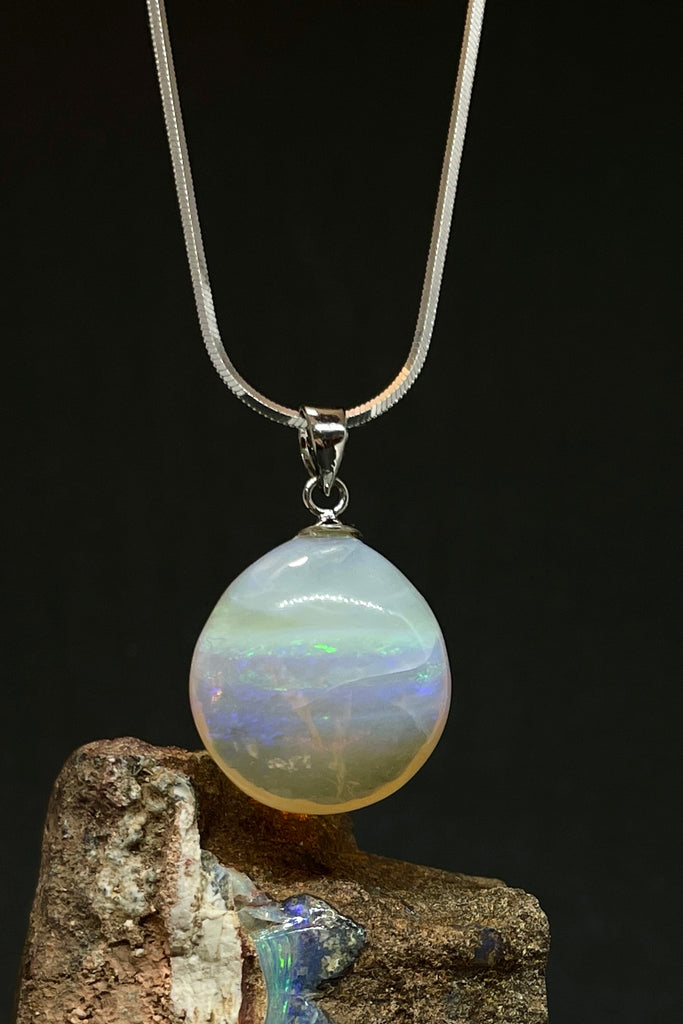 Absolute perfection, this lovely round stone looks like a pale misty moon, with soft blue, pale greeny yellow and tiny flashes of pink. The detail is across the stone and deep within, it is polished to a lovely soft finish. This piece has so much mystery. Australian Crystal Opal.