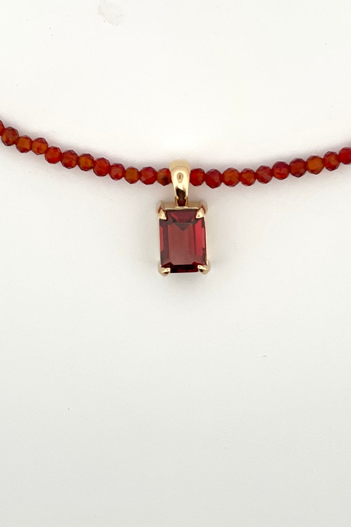 A delicate choker style necklace made with very tiny faceted and polished Carnelian beads, the centre piece is an emerald cut Garnet set in gold vermeil. Made for Mombasa Rose Boutique in Noosa Australia.