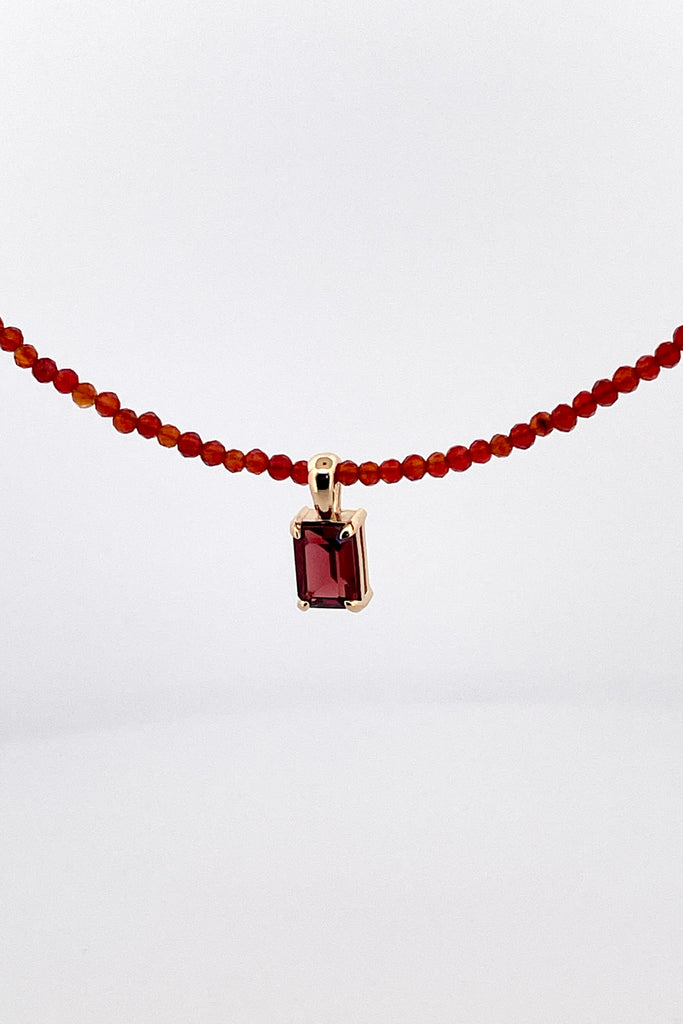 A delicate choker style necklace made with very tiny faceted and polished Carnelian beads, the centre piece is an emerald cut Garnet set in gold vermeil. Made for Mombasa Rose Boutique in Noosa Australia.