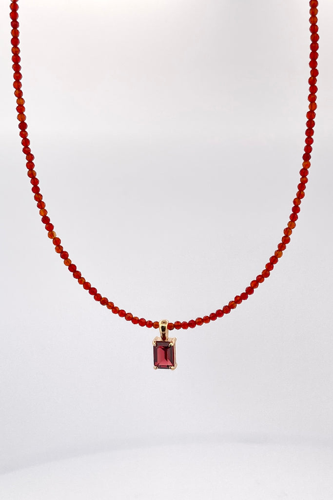 A delicate choker style necklace made with very tiny faceted and polished Carnelian beads, the centre piece is an emerald cut Garnet set in gold vermeil. Made for Mombasa Rose Boutique in Noosa Australia.