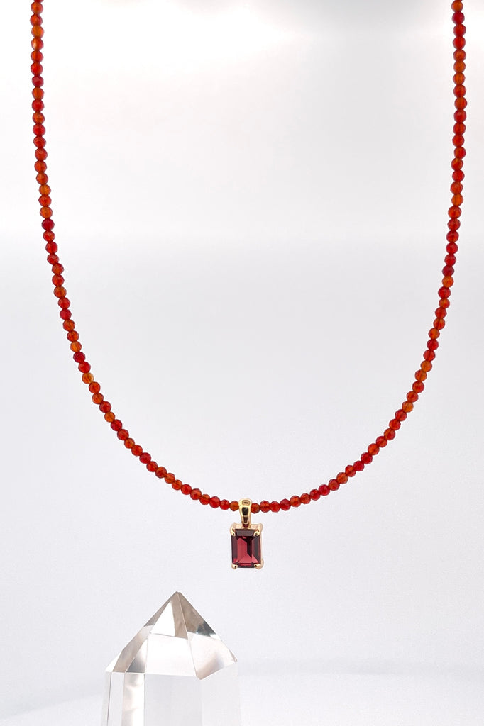 A delicate choker style necklace made with very tiny faceted and polished Carnelian beads, the centre piece is an emerald cut Garnet set in gold vermeil. Made for Mombasa Rose Boutique in Noosa Australia.