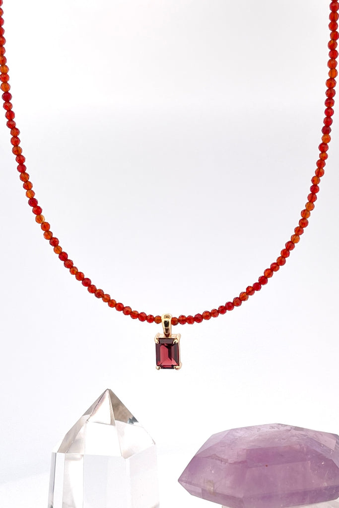 A delicate choker style necklace made with very tiny faceted and polished Carnelian beads, the centre piece is an emerald cut Garnet set in gold vermeil. Made for Mombasa Rose Boutique in Noosa Australia.