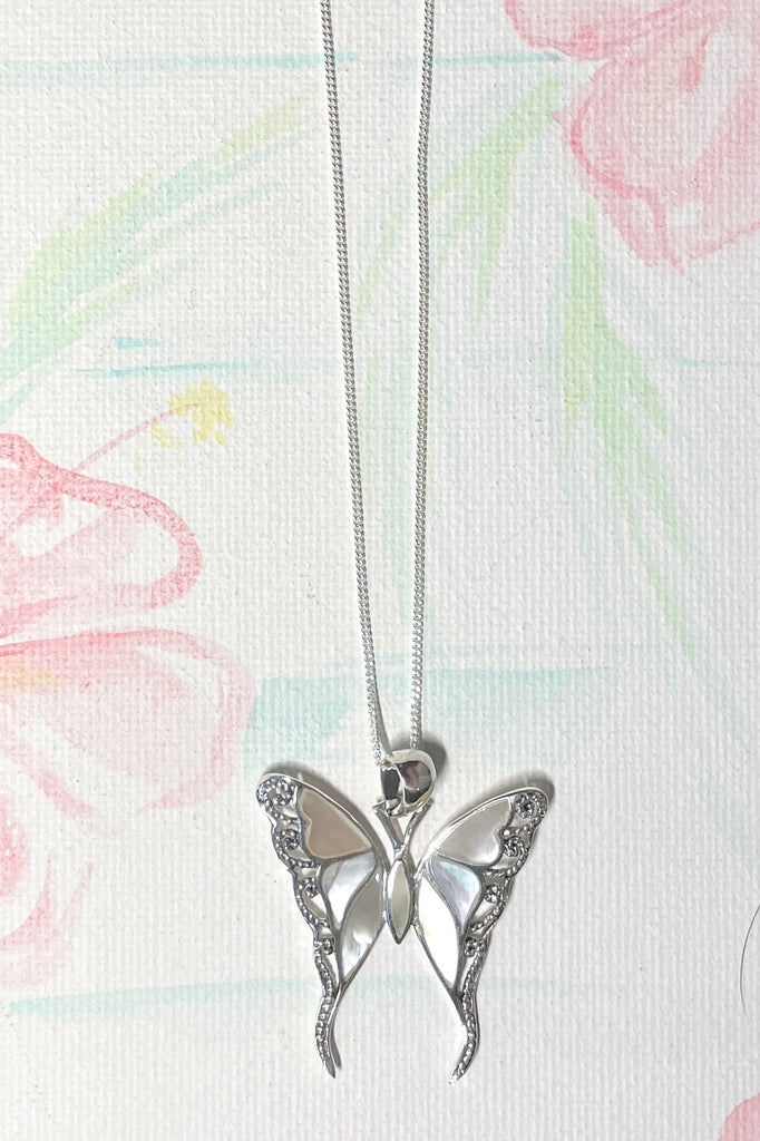 A gorgeous retro style butterfly necklace in shiny filigree silver with sea shell inlay.