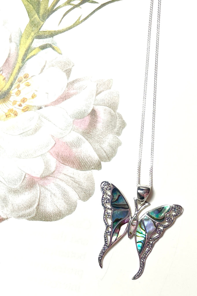 A charming butterfly necklace in shiny silver, with inlaid Mother of Pearl shell in palest pink..  