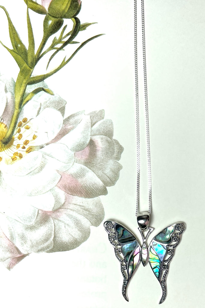 A charming butterfly necklace in shiny silver, with inlaid Mother of Pearl shell in palest pink..  
