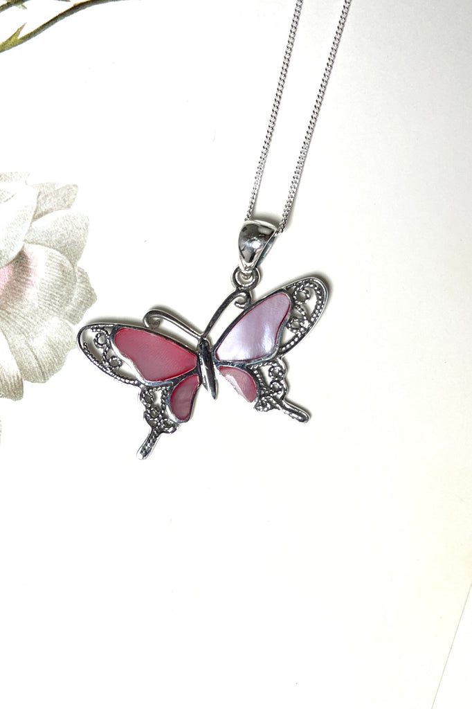 A charming butterfly necklace in shiny silver, with inlaid Mother of Pearl shell in palest pink..  