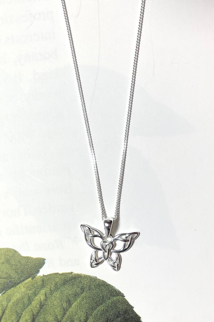 A charming butterfly necklace in shiny silver, with cut out patterns.