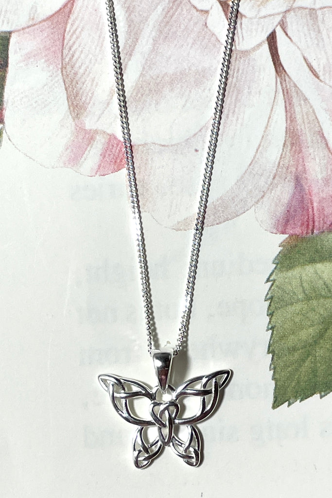 A charming butterfly necklace in shiny silver, with cut out patterns.