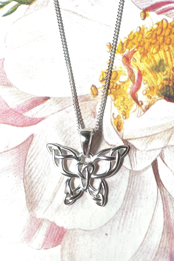 A charming butterfly necklace in shiny silver, with cut out patterns.