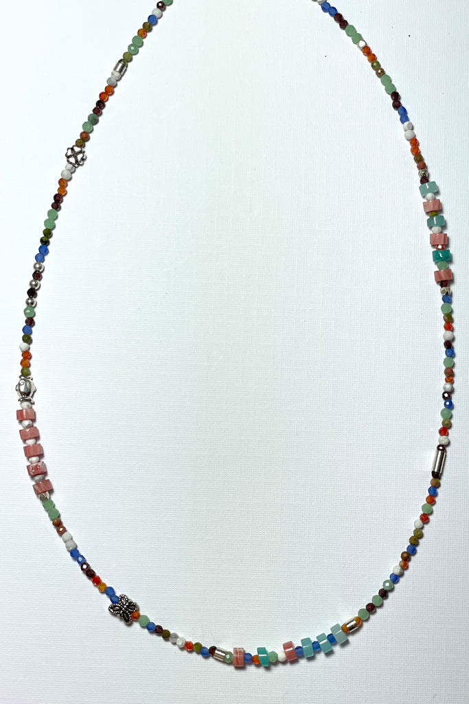 A choker style necklace made with an assortment of pretty cut, polished and faceted gemstones with silver highlight beads, this is a perfect summer beach boho style.