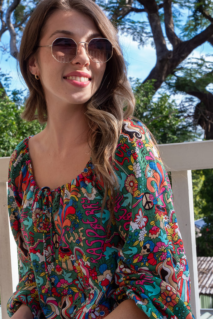 The Joni 60’s Print Boho Blouse is a gorgeous green based blouse with a 60s pop art print all over. The blouse features a drawstring neckline with front keyhole and long sleeves with elasticated cuffs. Made from a woven blend of cotton and rayon.