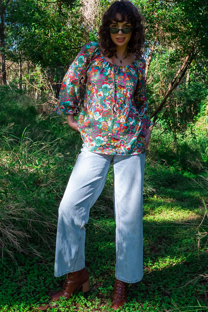 The Joni 60’s Print Boho Blouse is a gorgeous green based blouse with a 60s pop art print all over. The blouse features a drawstring neckline with front keyhole and long sleeves with elasticated cuffs. Made from a woven blend of cotton and rayon.