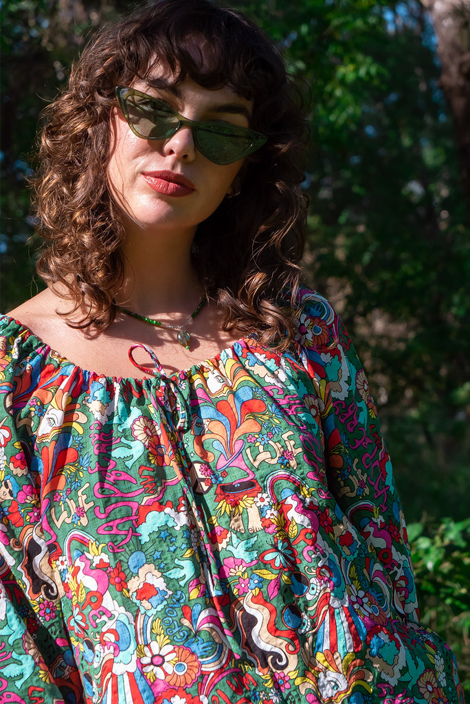The Joni 60’s Print Boho Blouse is a gorgeous green based blouse with a 60s pop art print all over. The blouse features a drawstring neckline with front keyhole and long sleeves with elasticated cuffs. Made from a woven blend of cotton and rayon.