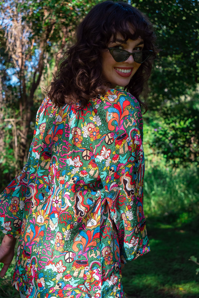 The Joni 60’s Print Boho Blouse is a gorgeous green based blouse with a 60s pop art print all over. The blouse features a drawstring neckline with front keyhole and long sleeves with elasticated cuffs. Made from a woven blend of cotton and rayon.