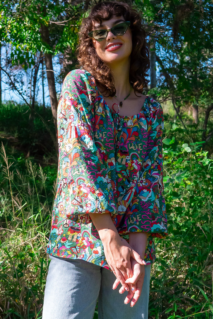 The Joni 60’s Print Boho Blouse is a gorgeous green based blouse with a 60s pop art print all over. The blouse features a drawstring neckline with front keyhole and long sleeves with elasticated cuffs. Made from a woven blend of cotton and rayon.