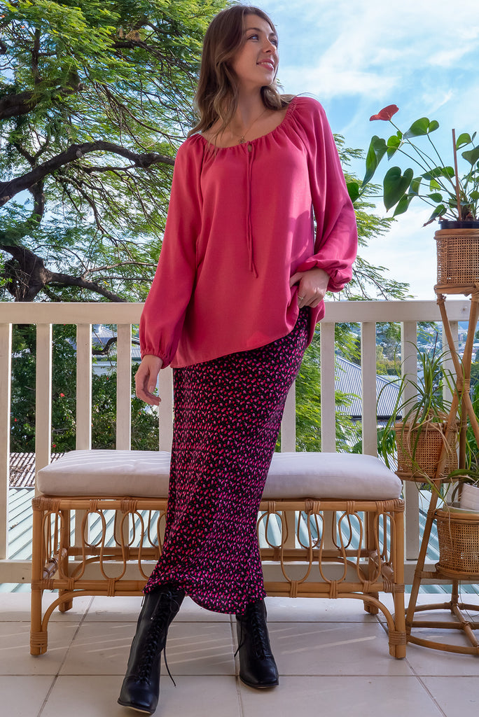 The Joni Berry Sparkle Boho Blouse is a beautiful deep pink blouse with a gold lurex shimmer all throughout. The blouse features a drawstring neckline with front keyhole and long sleeves with elasticated cuffs. Made from a woven blend of rayon, lurex, mulberry silk, and modal.