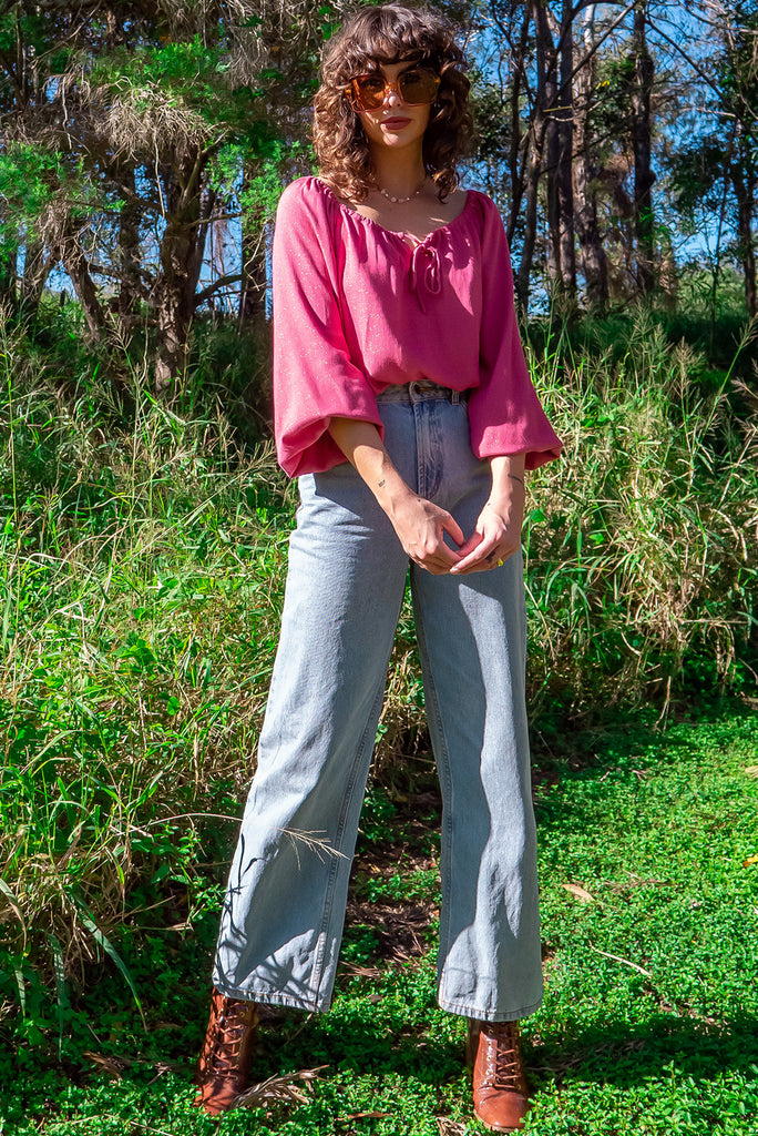 The Joni Berry Sparkle Boho Blouse is a beautiful deep pink blouse with a gold lurex shimmer all throughout. The blouse features a drawstring neckline with front keyhole and long sleeves with elasticated cuffs. Made from a woven blend of rayon, lurex, mulberry silk, and modal.