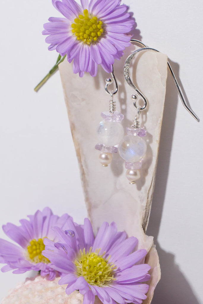 Drift into a galaxy of luminescent moons and pastel skies. Our Kunzite &amp; Moonstone Orb Earrings shimmer and shine. 