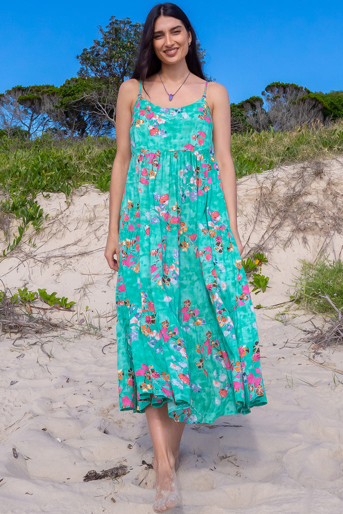 The Le Lagon Green Sea Glass Maxi Dress is a gorgeous sea green maxi dress with a green wash effect base and botanical print. The dress features silver heart beads on the shoulder straps, tiered skirting and side pockets. Made from a woven blend of cotton and rayon.