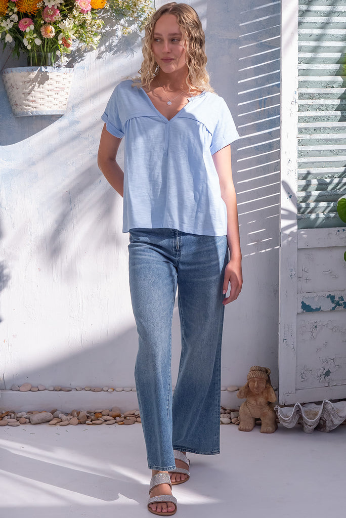 The Lei Tee Icey Cool Shirt is a beautiful ice blue t-shirt. The tee features a split neckline, rolled sleeve cuffs, and a gathered bust panel. Made from knit cotton.
