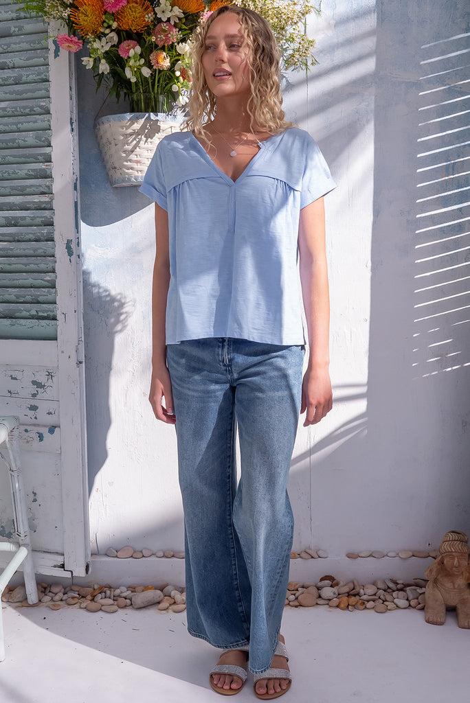 The Lei Tee Icey Cool Shirt is a beautiful ice blue t-shirt. The tee features a split neckline, rolled sleeve cuffs, and a gathered bust panel. Made from knit cotton.