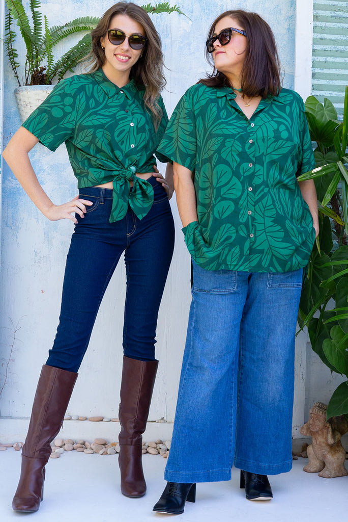 The Leonora Botany Green Short Sleeve Shirt is a tonal green relaxed fit button down shirt with botanical leaf print. The blouse features short sleeves, button down front, classic collar, one bust pocket, side slits, scooped hem at sides and slightly longer back. Made from woven 100% rayon.