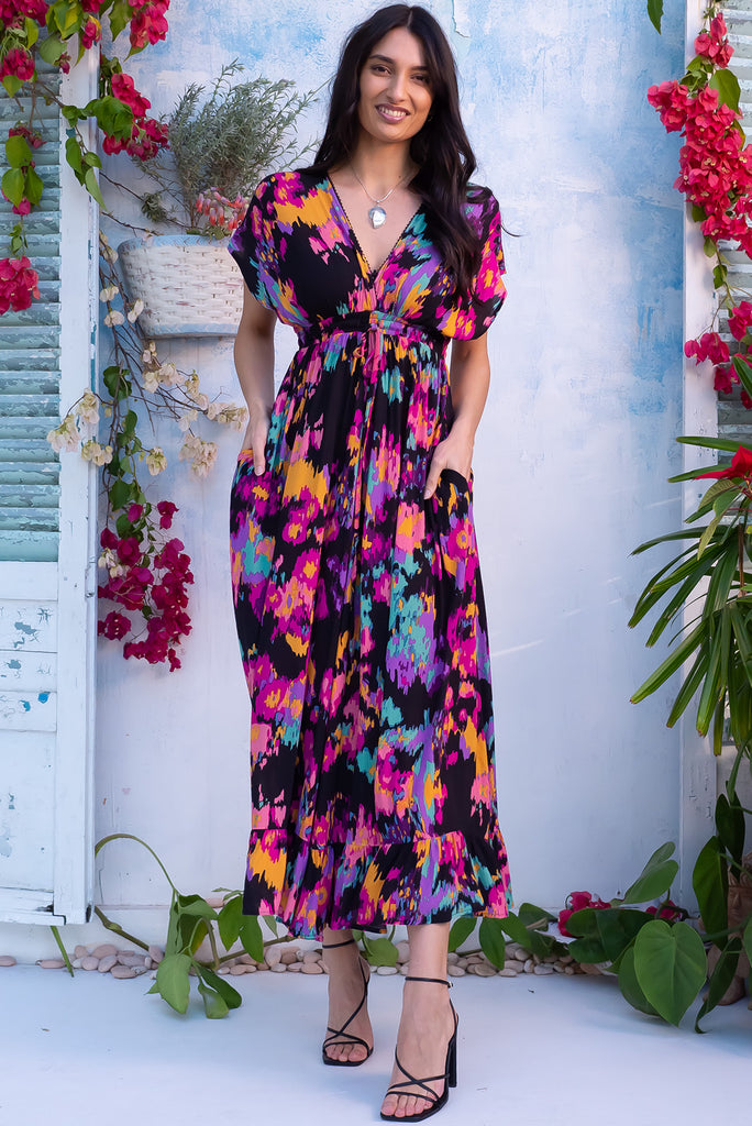 The Linden Art Class Maxi Dress is a gorgeous black maxi dress with a multicoloured splash print. The dress features dolman sleeves, an elasticated and drawstring empire line, v-neckline, and side pockets. Made from crinkle rayon. 