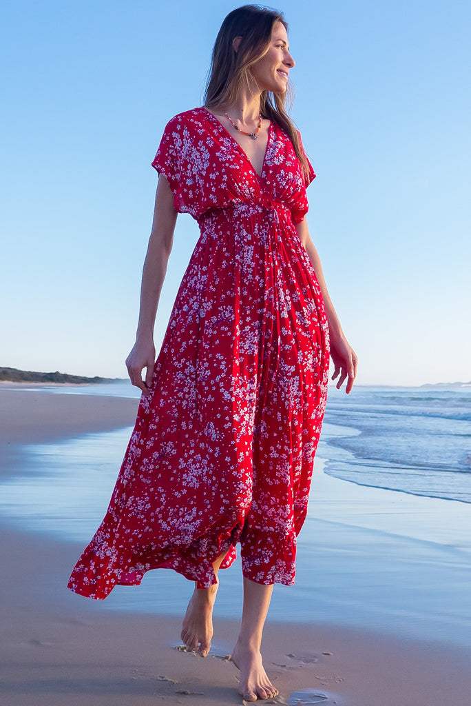 The Linden Red Flora Maxi Dress is a gorgeous red maxi dress with a white cherry blossom print. The dress features dollar sleeves, an elasticated and drawstring empire line, v-neckline, and side pockets. Made from crinkle rayon.