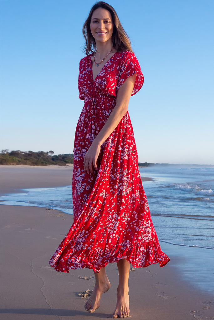The Linden Red Flora Maxi Dress is a gorgeous red maxi dress with a white cherry blossom print. The dress features dollar sleeves, an elasticated and drawstring empire line, v-neckline, and side pockets. Made from crinkle rayon.