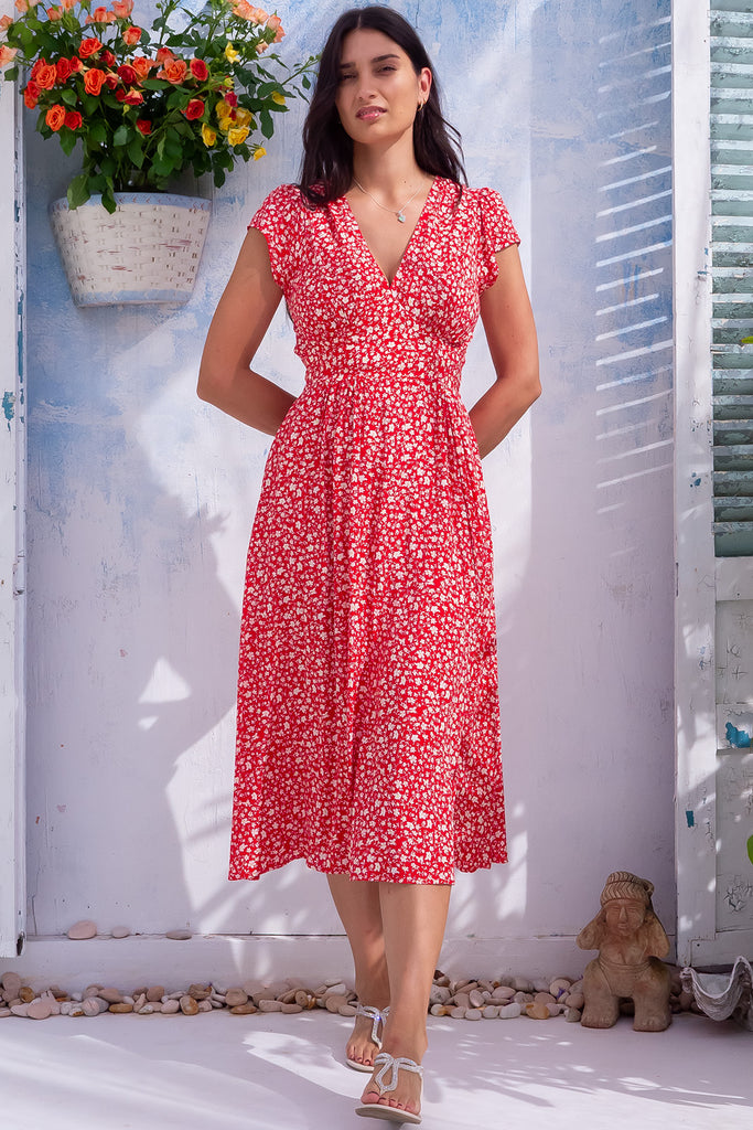 The Lizzie Red Ditzy Midi Dress is a gorgeous red midi dress with a white ditzy floral print. The dress features a Basque waist, feminine cut and gathered bust. Made from 100% rayon. 