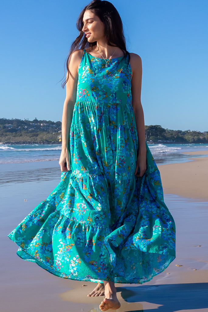 The Lulu Darling Blue Bubble Maxi Dress is a beautiful blue wash effect based dress with a multicoloured bubble print. The maxi dress features a high neck with thin straps, high cut under arms, full tiered skirting from the bust down and deep side pockets. Made from a cotton / rayon woven blend.